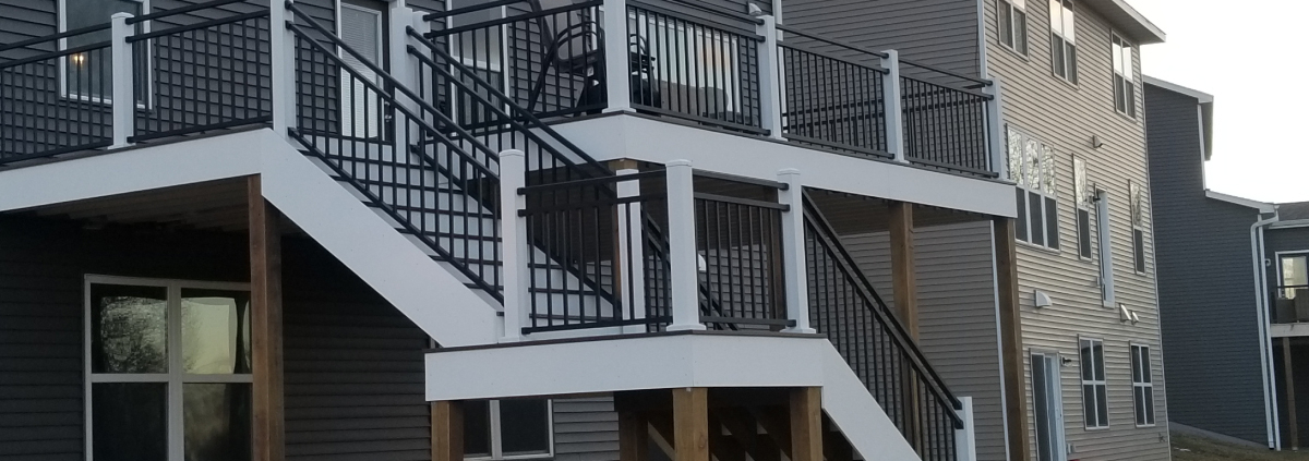 new deck construction with white trim and black railings - Barefoot Construction Deck Construction, Basement Finishings and Home Additions