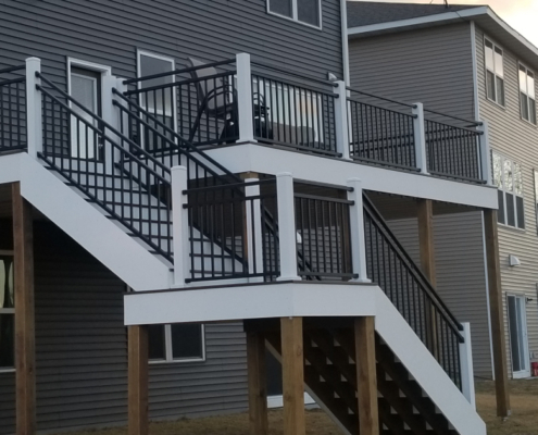 new deck construction with white trim and black railings - Barefoot Construction Deck Construction, Basement Finishings and Home Additions