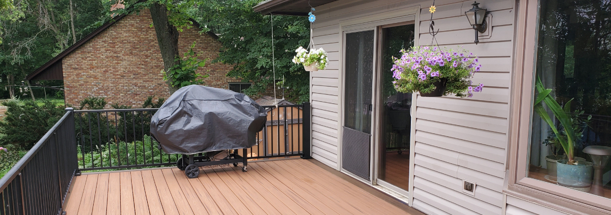 new deck with covered grill and black railings - Barefoot Construction Deck Construction, Basement Finishings and Home Additions