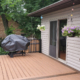 new deck with covered grill and black railings - Barefoot Construction Deck Construction, Basement Finishings and Home Additions