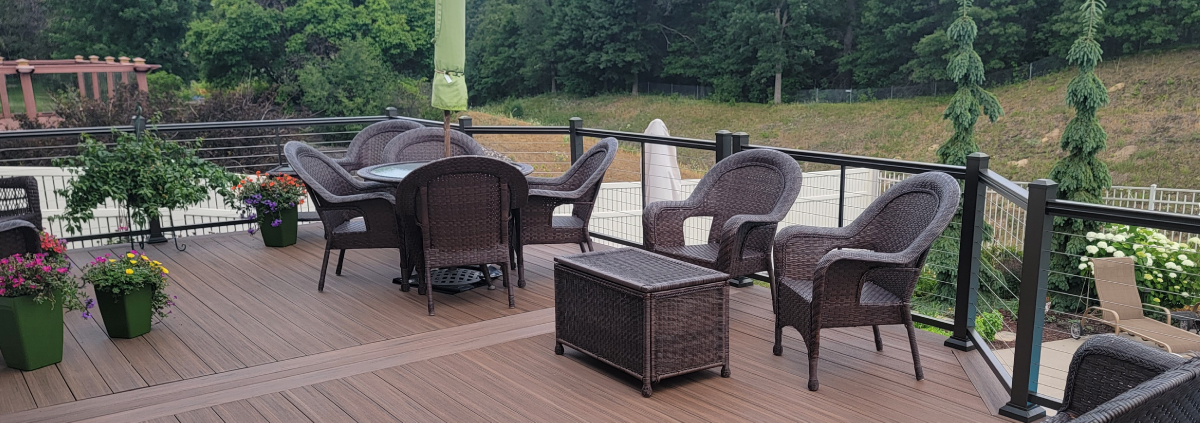finished composite deck with patio furniture - Barefoot Construction Deck Construction, Basement Finishings and Home Additions