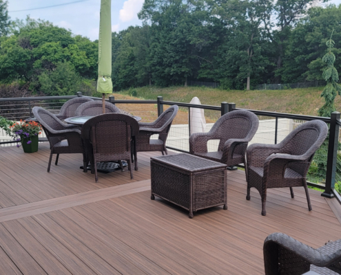 finished composite deck with patio furniture - Barefoot Construction Deck Construction, Basement Finishings and Home Additions