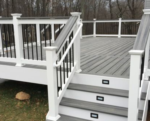 new deck with grey deck boards and black railings - Barefoot Construction Deck Construction, Basement Finishings and Home Additions