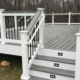 new deck with grey deck boards and black railings - Barefoot Construction Deck Construction, Basement Finishings and Home Additions