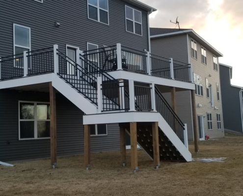new deck with white and black railings - Barefoot Construction Deck Construction, Basement Finishings and Home Additions