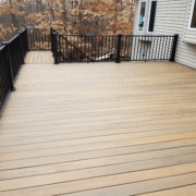 new wood deck with black railings - Barefoot Construction Deck Construction, Basement Finishings and Home Additions