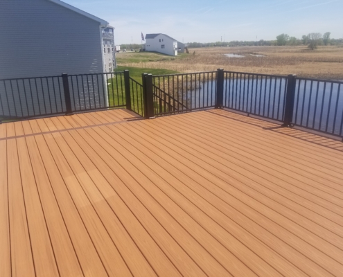 new deck with black railings - Barefoot Construction Deck Construction, Basement Finishings and Home Additions