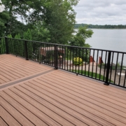 new deck with black railings and a lake view - Barefoot Construction Deck Construction, Basement Finishings and Home Additions