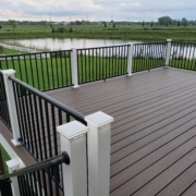 new deck with brown boards and black railings - Barefoot Construction Deck Construction, Basement Finishings and Home Additions