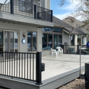 new deck with light grey boards and black railings - Barefoot Construction Deck Construction, Basement Finishings and Home Additions