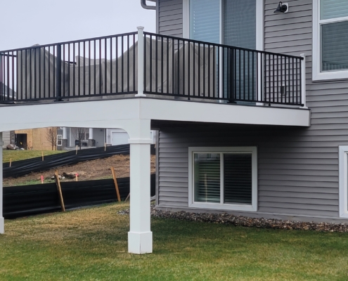 new deck with black railings - Barefoot Construction Deck Construction, Basement Finishings and Home Additions