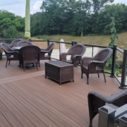 new deck with a pool view and patio furniture - Barefoot Construction Deck Construction, Basement Finishings and Home Additions