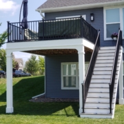 new second story deck with a blue patio umbrella - Barefoot Construction Deck Construction, Basement Finishings and Home Additions