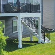 new second story deck with a blue patio umbrella - Barefoot Construction Deck Construction, Basement Finishings and Home Additions