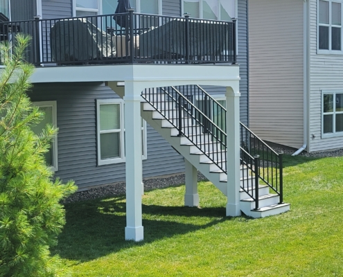 new second story deck with a blue patio umbrella - Barefoot Construction Deck Construction, Basement Finishings and Home Additions