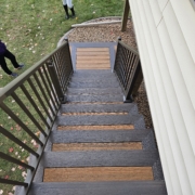 new composite deck stairs with brown railing - Barefoot Construction Deck Construction, Basement Finishings and Home Additions