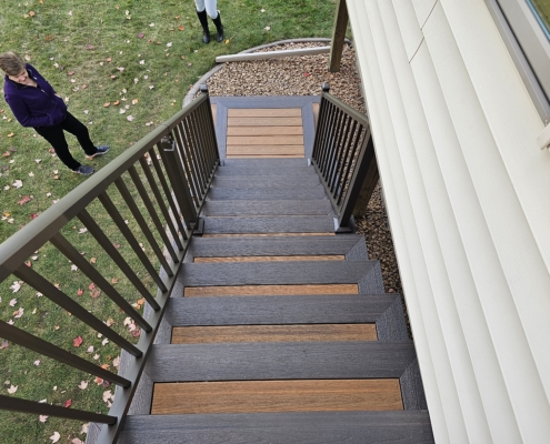 new composite deck stairs with brown railing - Barefoot Construction Deck Construction, Basement Finishings and Home Additions