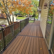 new deck with brown metal railings - Barefoot Construction Deck Construction, Basement Finishings and Home Additions