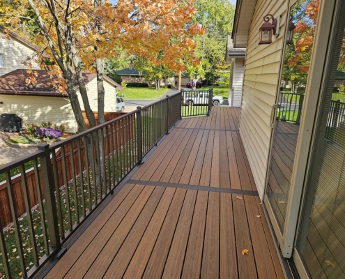 new deck with brown metal railings - Barefoot Construction Deck Construction, Basement Finishings and Home Additions