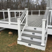 new deck with grey deck boards and white finishes - Barefoot Construction Deck Construction, Basement Finishings and Home Additions