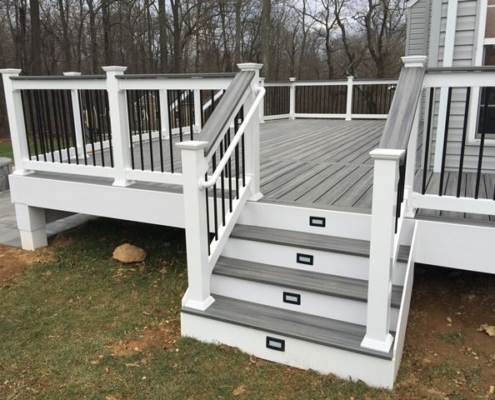 new deck with grey deck boards and white finishes - Barefoot Construction Deck Construction, Basement Finishings and Home Additions