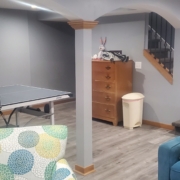 finished basement with stone fireplace and ping pong table - Barefoot Construction Deck Construction, Basement Finishings and Home Additions
