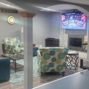 finished basement with stone fireplace and ping pong table - Barefoot Construction Deck Construction, Basement Finishings and Home Additions