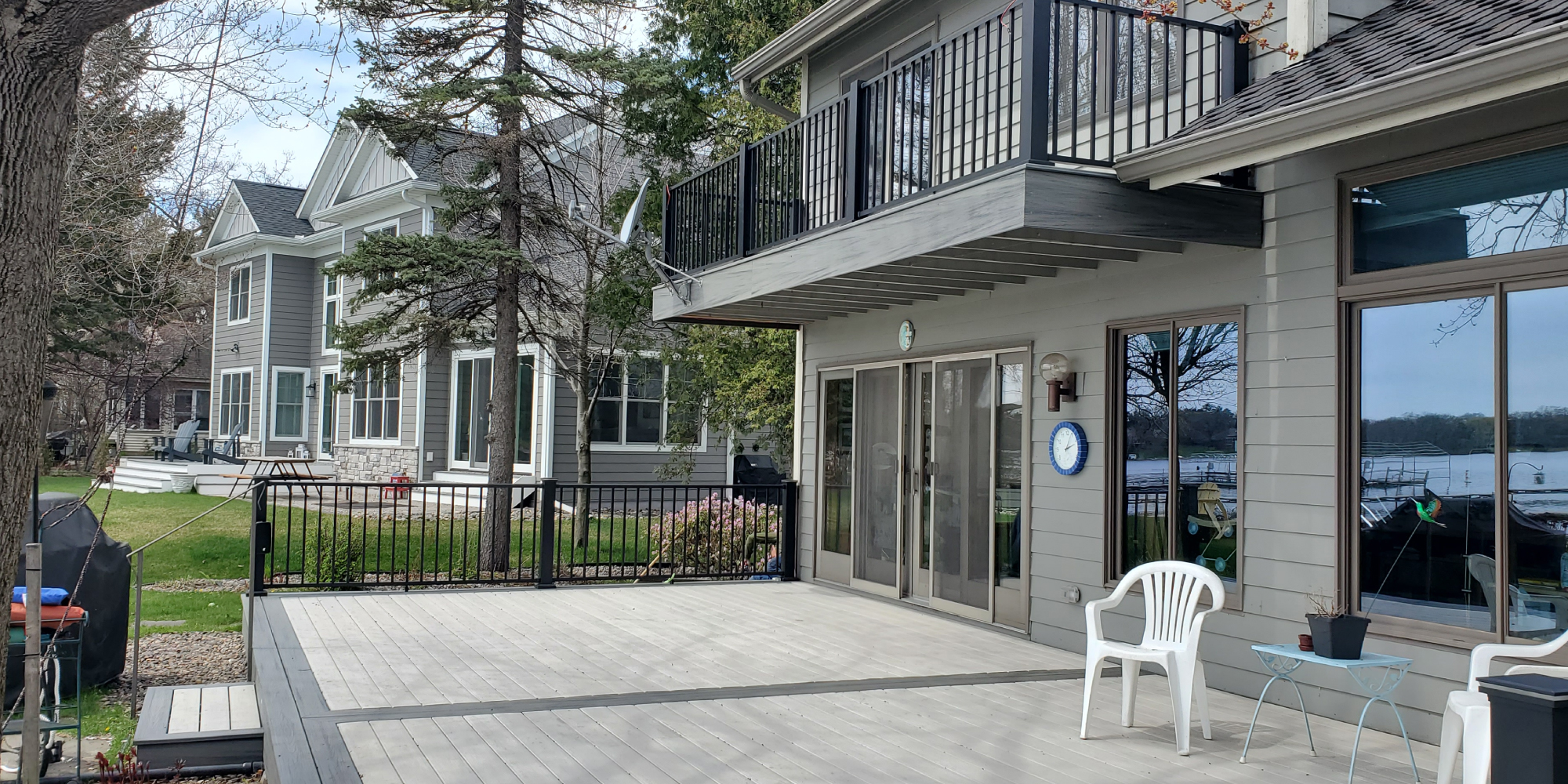 new composite deck with black railings and grey deck boards - Barefoot Construction Deck Construction, Basement Finishings and Home Additions