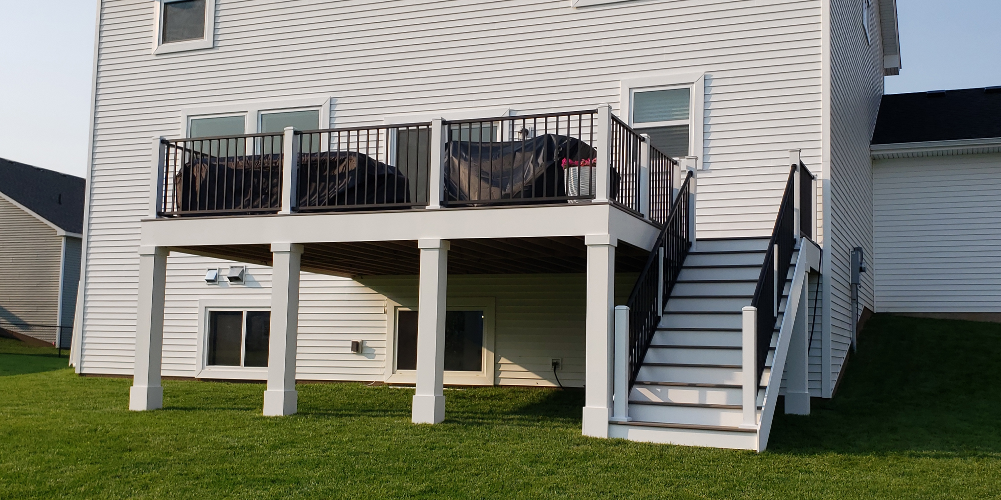 new composite deck with covered patio furniture - Barefoot Construction Deck Construction, Basement Finishings and Home Additions