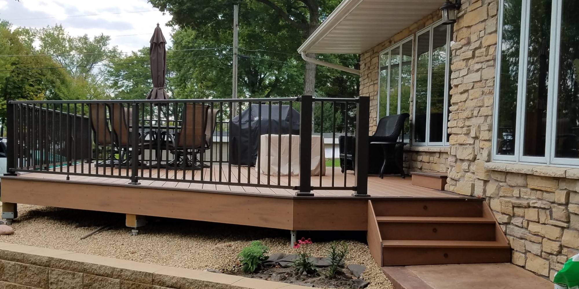 new deck with black railings - Barefoot Construction Deck Construction, Basement Finishings and Home Additions