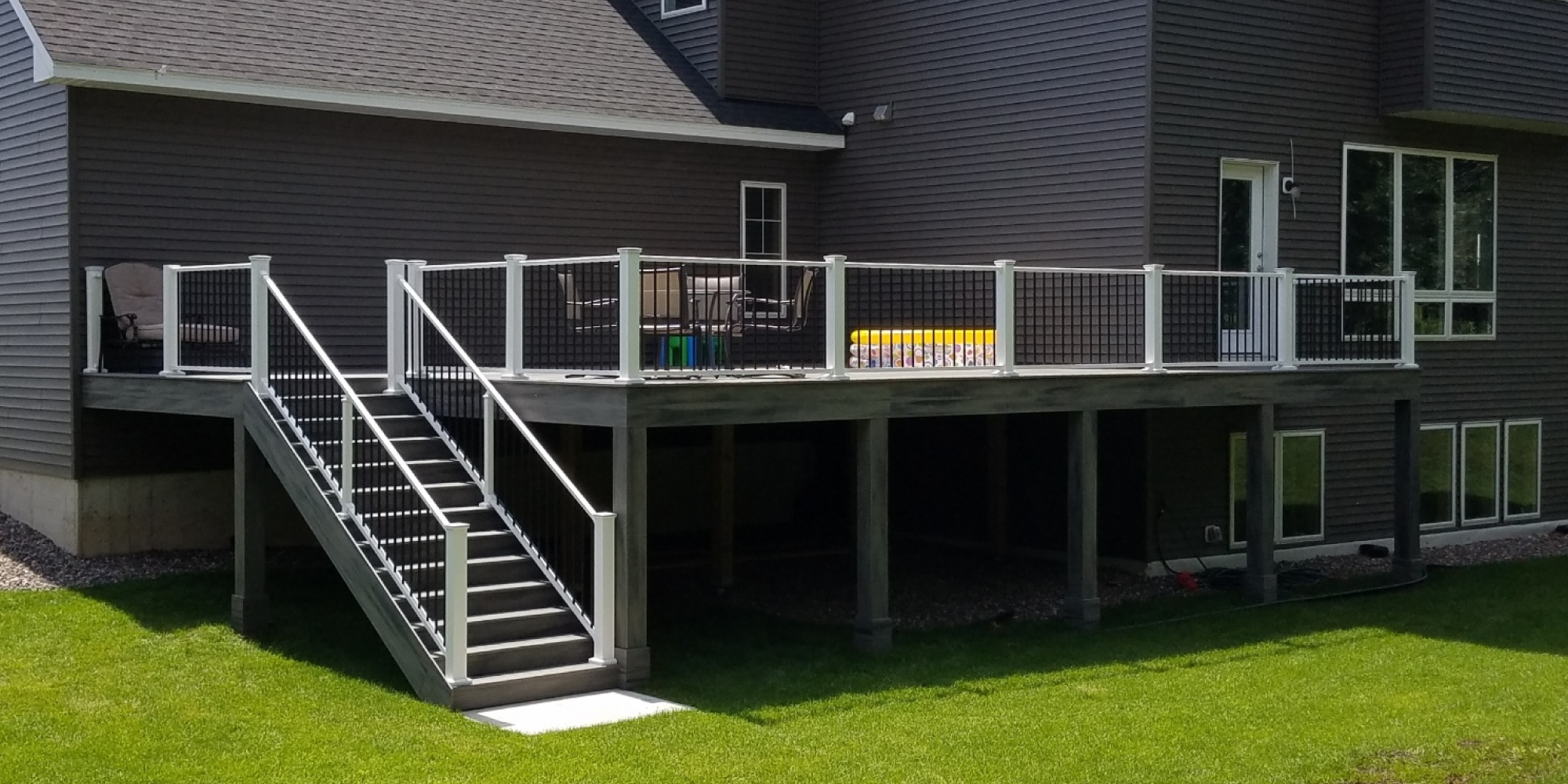 new deck construction with white and black railings - Barefoot Construction Deck Construction