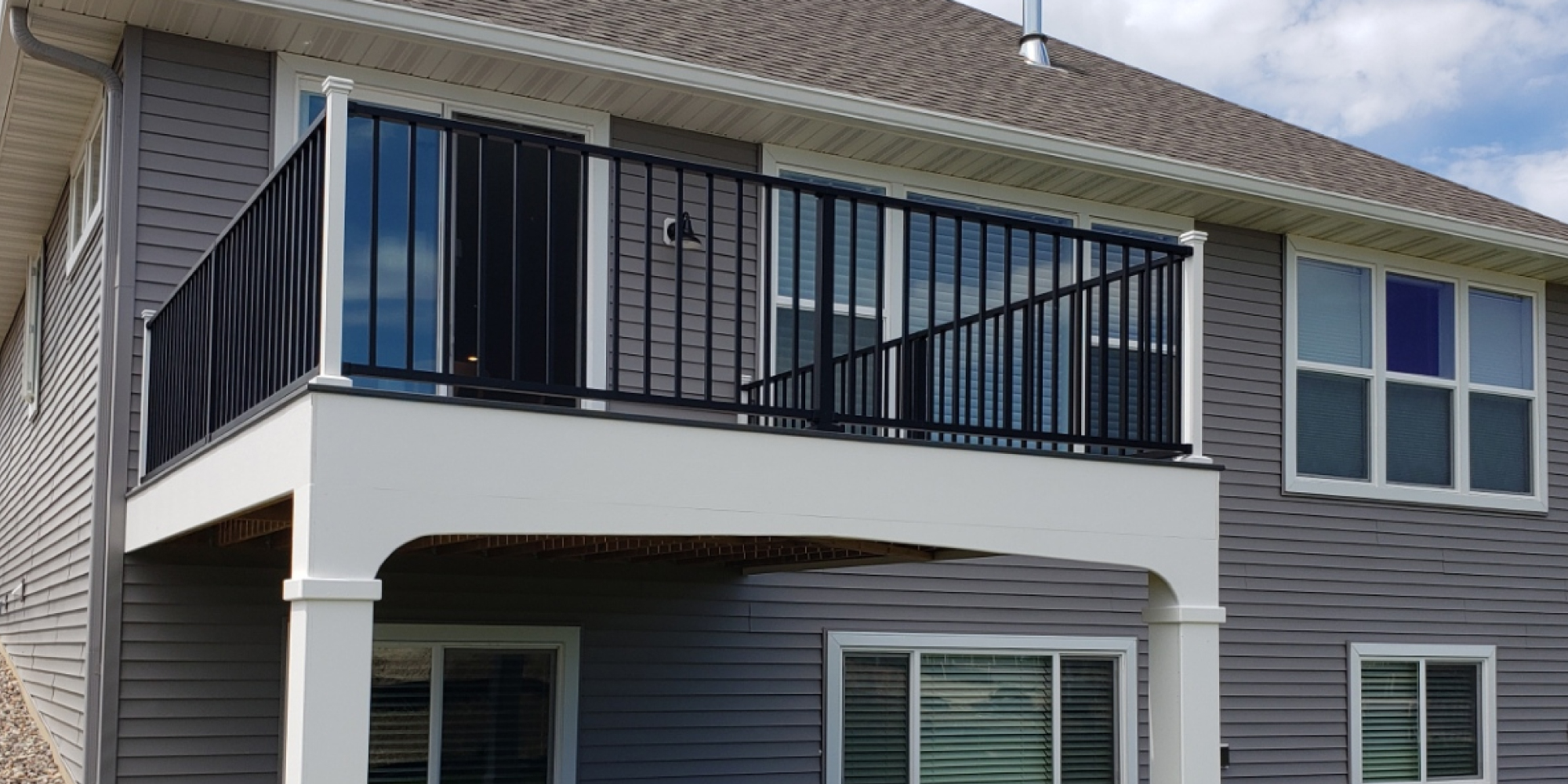 new composite deck with black railings - Barefoot Construction Deck Construction, Basement Finishings and Home Additions