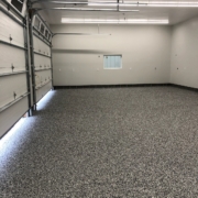 finished garage with epoxy flooring - Barefoot Construction Deck Construction, Basement Finishings and Home Additions