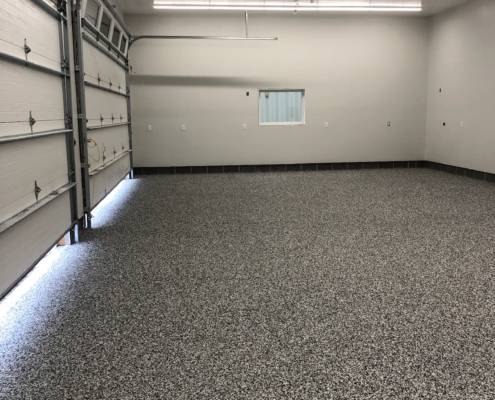 finished garage with epoxy flooring - Barefoot Construction Deck Construction, Basement Finishings and Home Additions