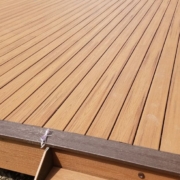 newly built composite deck with dark brown border - Barefoot Construction deck construction