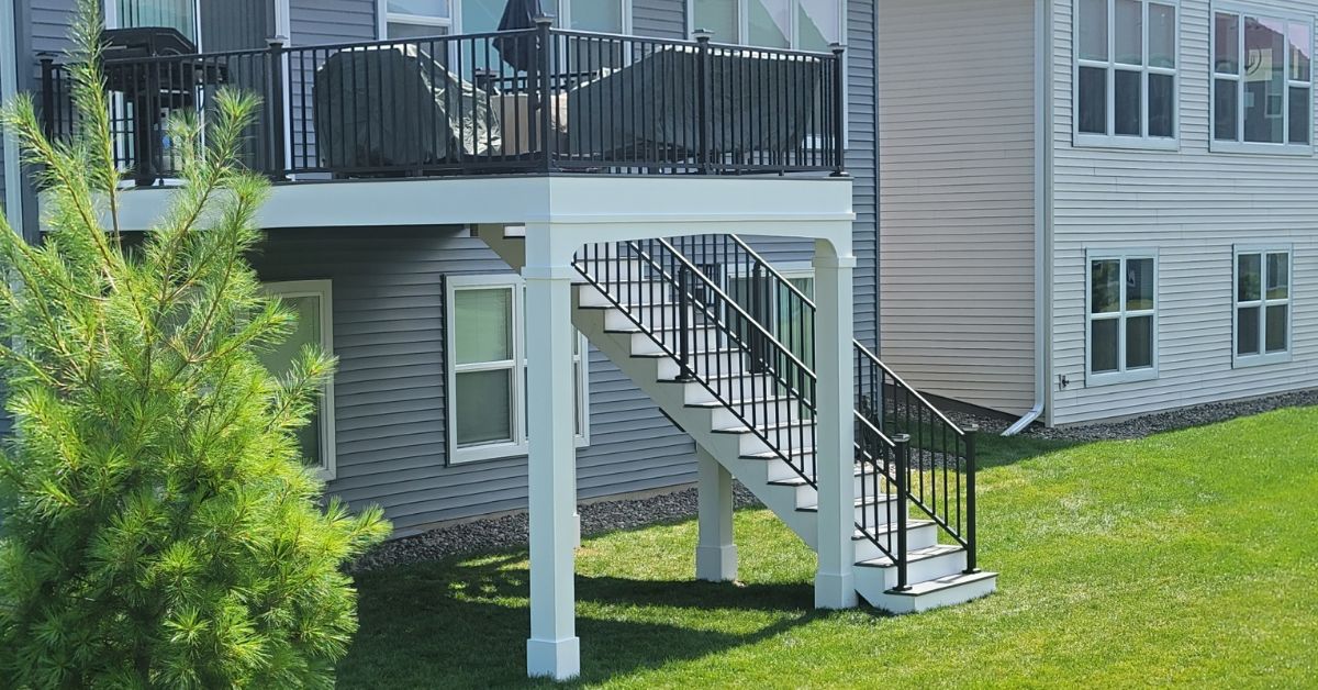 newly built deck with black railings and white trim - Barefoot Construction deck builders near
