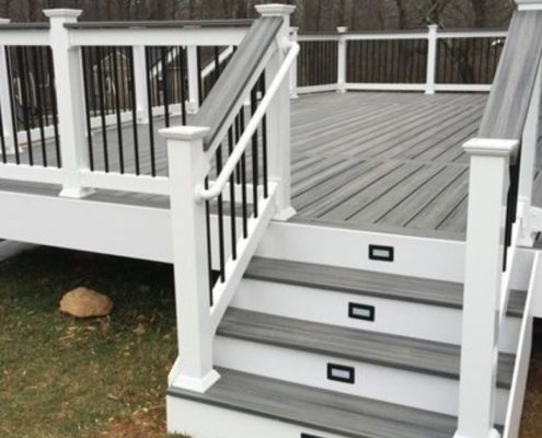 grey and white deck with black railings - Barefoot Construction Strategic Deck Lighting Ideas