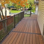 newly built deck with black railings - Barefoot Construction composite decking