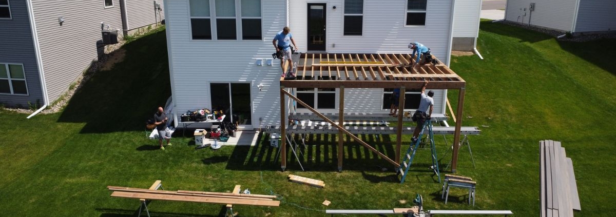 workers building a new wood deck - Barefoot Construction deck builders near me