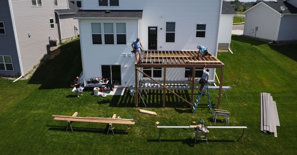 workers building a new wood deck - Barefoot Construction deck builders near