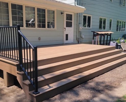 new construction deck with black railings - Barefoot Construction composite deck construction