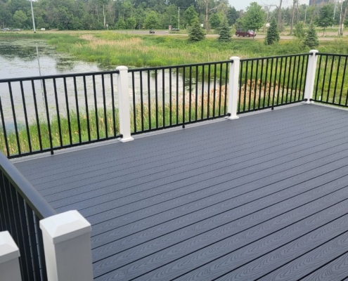newly built deck with a pond view - Barefoot Construction composite decking