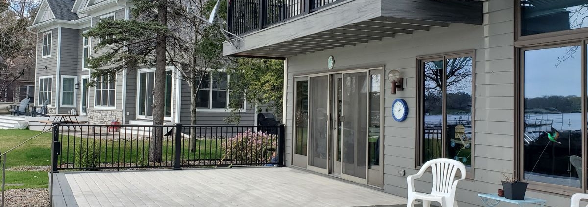 newly constructed grey deck with black railings - Barefoot Construction deck builder
