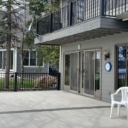 newly constructed grey deck with black railings - Barefoot Construction deck builder