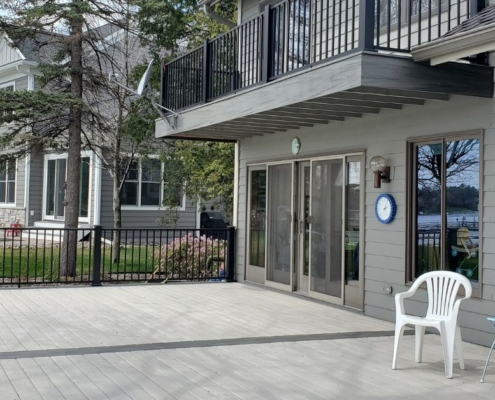 newly constructed grey deck with black railings - Barefoot Construction deck builder