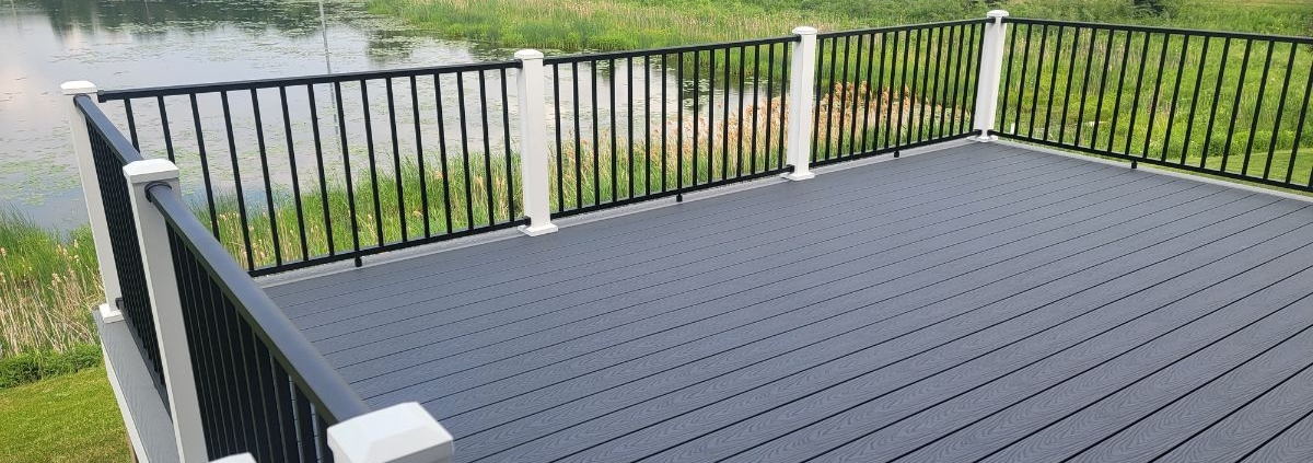 newly built deck with a pond view - Barefoot Construction composite decking