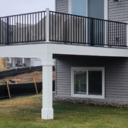 BarefootConstruction-deck-builders-near-082920242 new deck with white columns and black railings - Barefoot Construction deck builders near