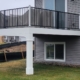 new deck with white columns and black railings - Barefoot Construction deck builders near