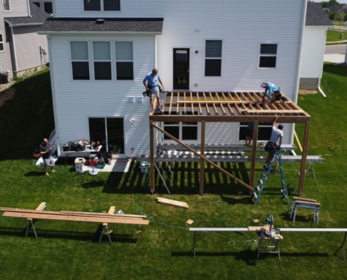 workers building a new wood deck - Barefoot Construction deck builder