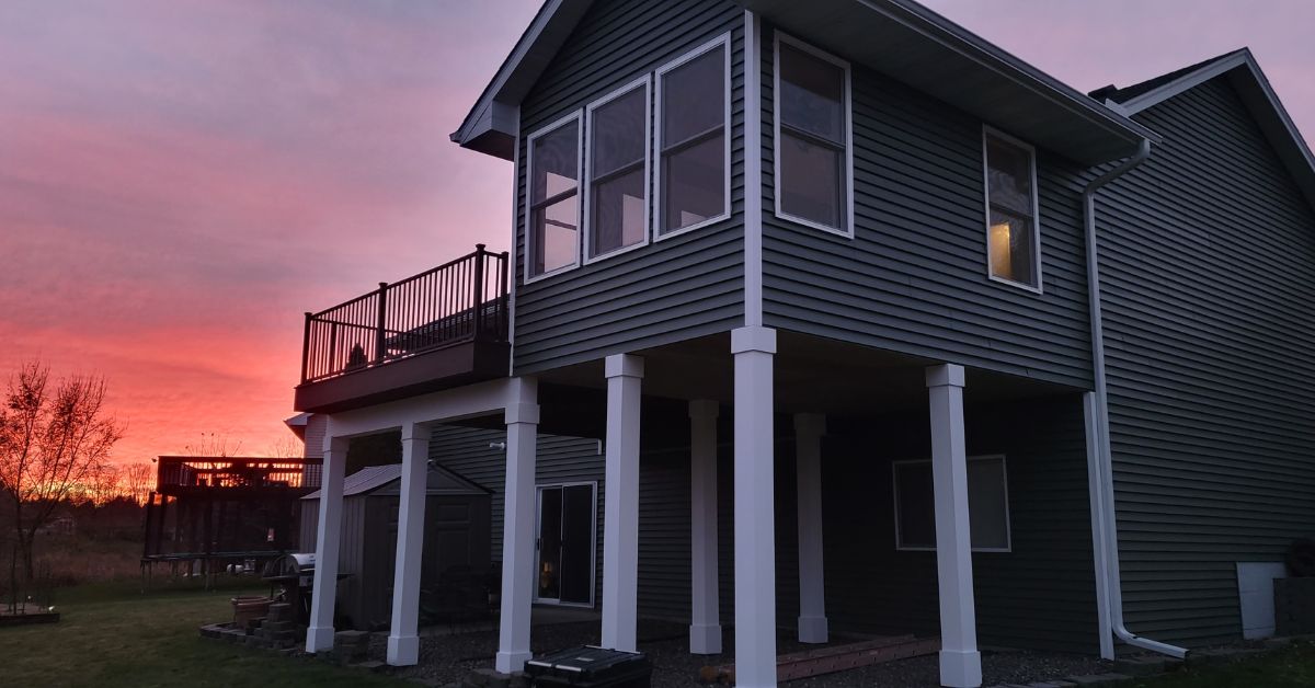 home addition on white columns - Barefoot Construction home addition